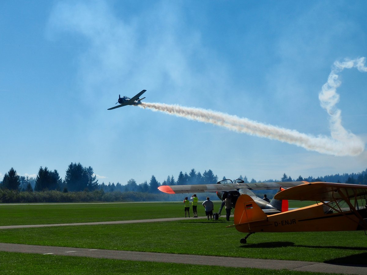 A flyby of an aeroplane over an airfield.